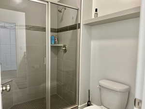 Bathroom with toilet and an enclosed shower