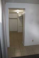 Hallway featuring light tile patterned flooring