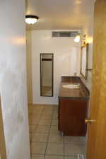 Bathroom with tile patterned floors and vanity