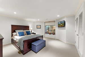 Carpeted bedroom featuring ornamental molding