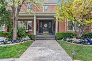 View of exterior entry featuring a lawn