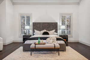 Bedroom featuring dark hardwood / wood-style floors and crown molding