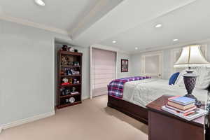 Carpeted bedroom with crown molding