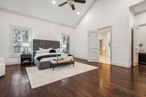 Bedroom featuring ceiling fan, dark hardwood / wood-style floors, ornamental molding, and high vaulted ceiling