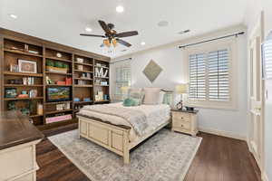 Bedroom featuring multiple windows, ceiling fan, dark hardwood / wood-style flooring, and ornamental molding