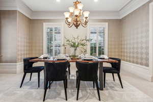 Dining area featuring light carpet, a wealth of natural light, and ornamental molding