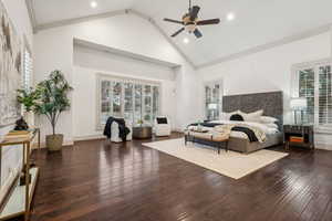 Bedroom with ornamental molding, high vaulted ceiling, ceiling fan, and dark wood-type flooring