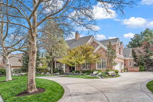 View of front of property with a garage and a front lawn