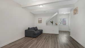 Sitting room featuring hardwood / wood-style floors and beam ceiling