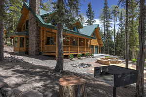 Rear view of house featuring a fire pit and a porch