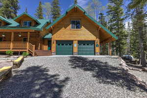 Log cabin featuring a porch