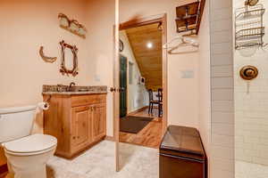 Bathroom with a shower, lofted ceiling, vanity, wood ceiling, and hardwood / wood-style flooring