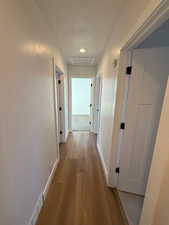 Hallway with light hardwood / wood-style floors