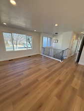 Unfurnished room featuring a textured ceiling and light hardwood / wood-style floors