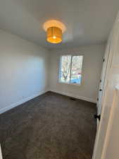 Carpeted empty room featuring a textured ceiling