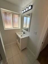 Bathroom featuring tile patterned floors and vanity