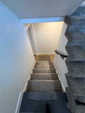 Stairway featuring wood-type flooring