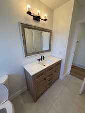 Bathroom featuring tile patterned floors, vanity, and toilet