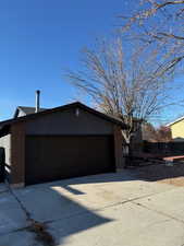 View of side of property with a garage and an outdoor structure