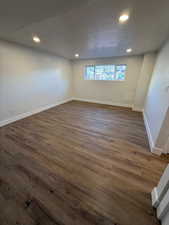 Empty room featuring dark hardwood / wood-style floors