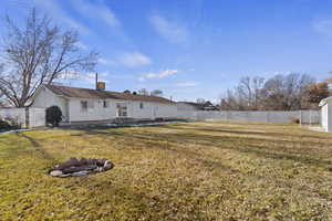 Back of house with a yard