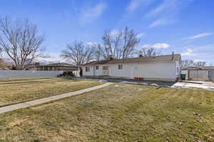 Back of property featuring a lawn