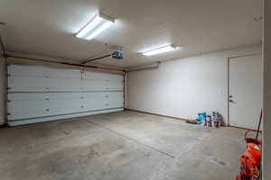 2 car Garage featuring a garage door opener and storage