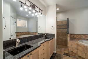 Primary Bathroom featuring walk in shower and granite vanity.