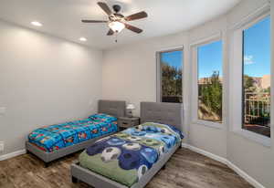 2nd Bedroom with curved wall and large windows looking out on private courtyard