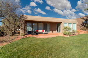 Rear view of property featuring a patio, and a yard