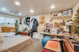 Bedroom featuring a textured ceiling and carpet floors