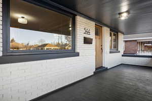 Doorway to property featuring a porch