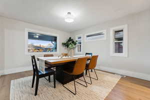 Dining area with a healthy amount of sunlight and light hardwood / wood-style floors