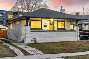 View of front of house with a lawn and covered porch