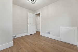 Spare room with light wood-type flooring