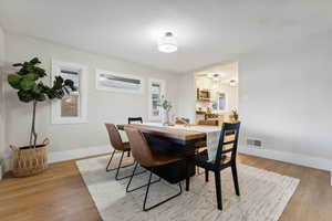 Dining room with light hardwood / wood-style floors and plenty of natural light