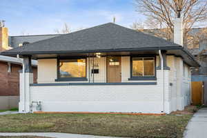 Exterior space featuring a lawn and covered porch