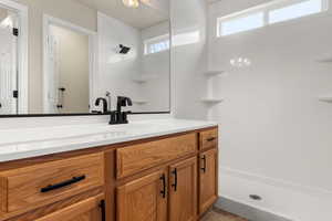 Bathroom featuring a shower and vanity