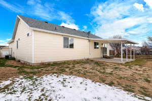 Snow covered property featuring a patio and central AC