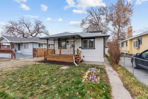 View of front of property featuring covered porch and a front lawn