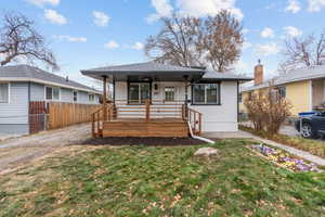 Bungalow-style house featuring a porch and a front yard