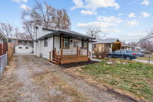 View of front of home with covered porch and an outdoor structure