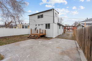 Back of house featuring a patio and a wooden deck