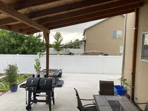 View of patio featuring a grill