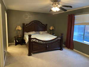 Bedroom with ceiling fan and light carpet