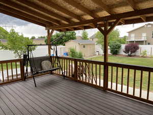 Wooden deck with a lawn and a storage shed