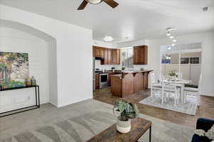 Kitchen featuring  a kitchen breakfast bar, pendant lighting, and stainless steel electric range