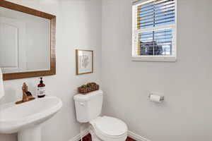 Bathroom with sink and toilet on main floor.