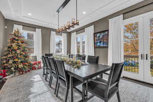 Dining area featuring french doors, a healthy amount of sunlight, and an inviting chandelier