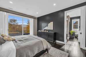 Bedroom featuring access to outside and dark wood-type flooring